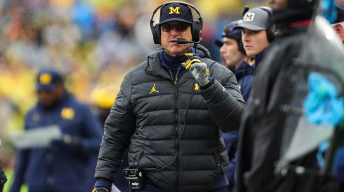 Michigan head coach Jim Harbaugh looks on while coaching during a game.